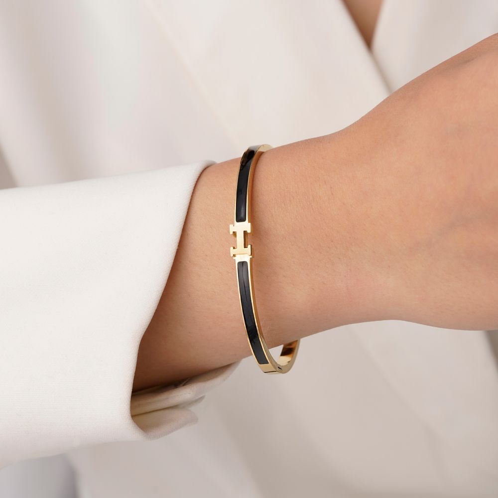 تصویر دستبند النگویی استیل 304 هرمس مشکی سایز سه 4 میل طلایی